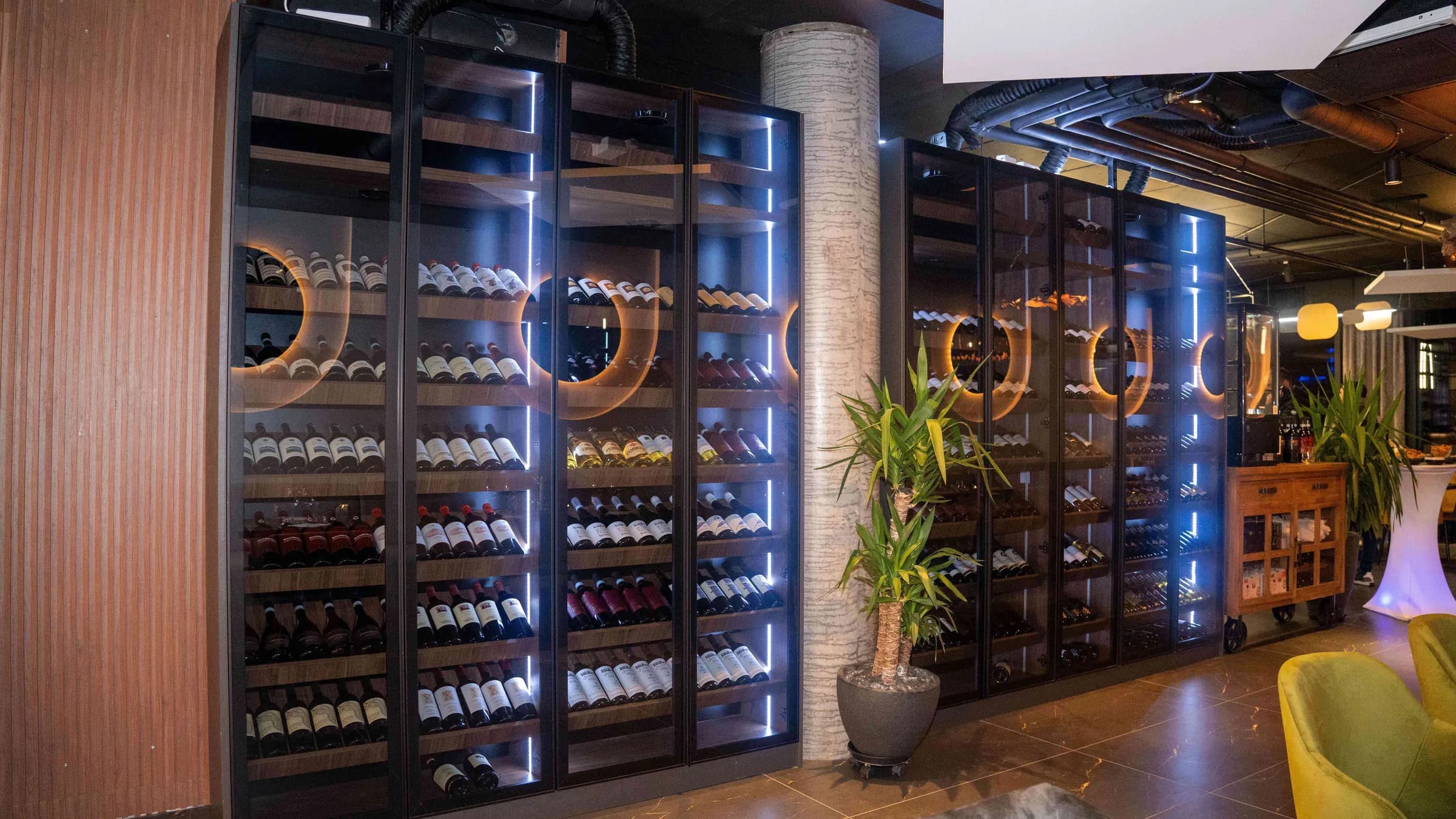 The glass-walled wine cellar