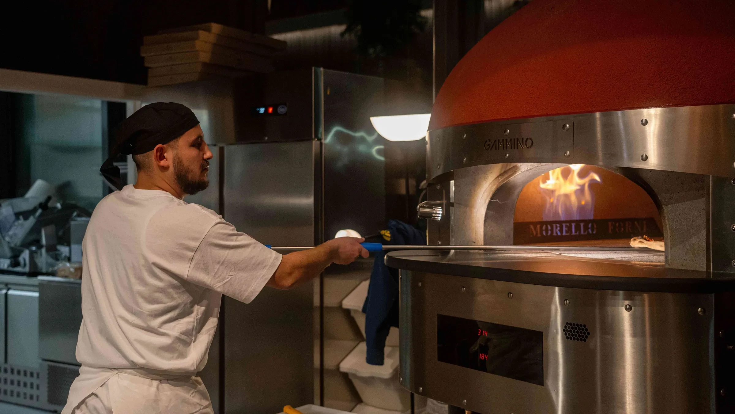 The pizzaiolo at the oven