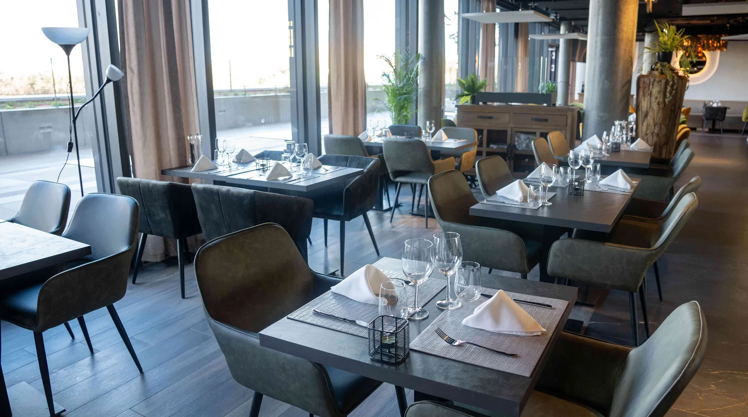 The bright dining room at Nostra Italia, tables set